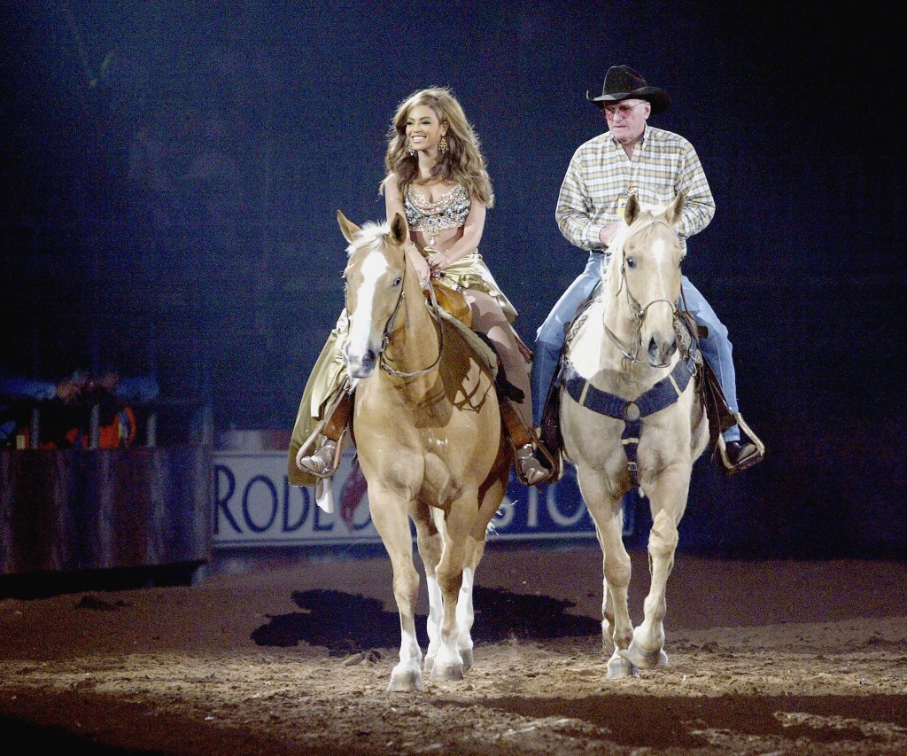 HOUSTON, TX - MARCH 18: Singer Beyonce Knowles arrives on horseback to perform for her hometown crowd at the Houston Livestock Show and Rodeo, March 18, 2004 in Houston, Texas. Beyonce and her dancers had their wardrobe designed by Dolce and Gabbana and styled by Tina Knowles, with the male dancers styled by Timothy White. (Photo by Frank Micelotta/Getty Images)