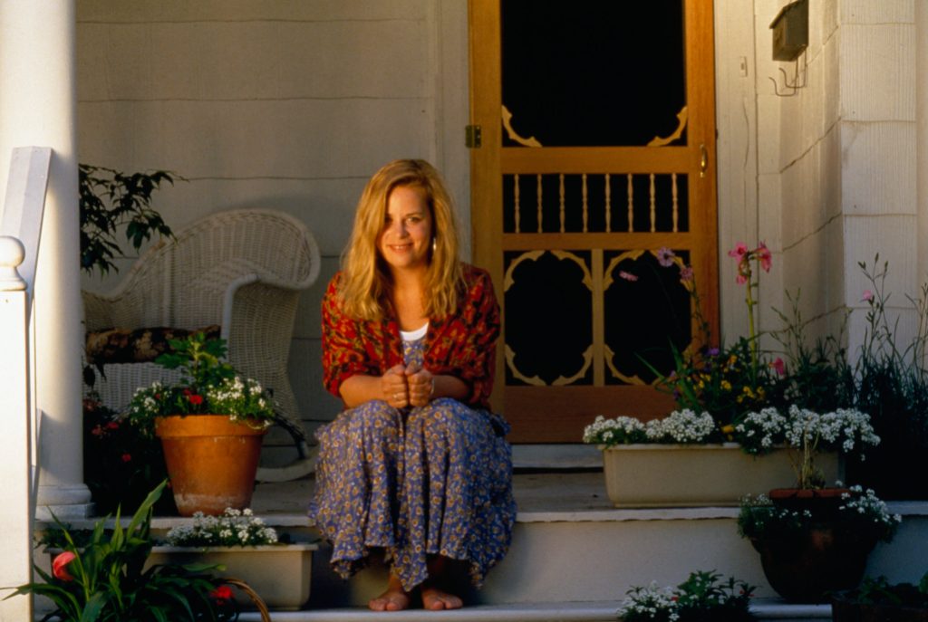 Portrait of Mary Chapin Carpenter sitting on steps 