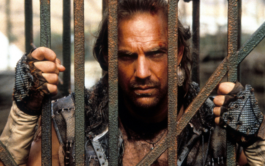 Kevin Costner behind bars in a scene from the film 'Waterworld'