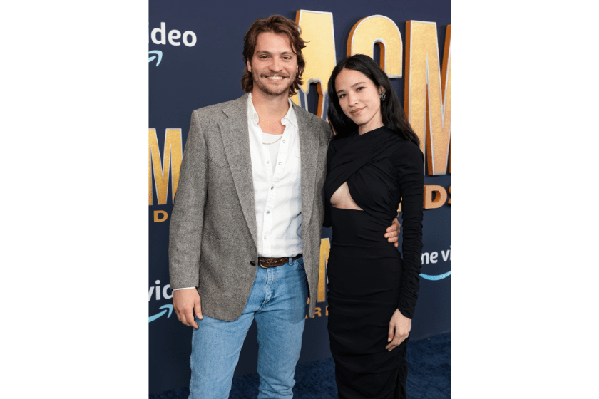 Luke Grimes and Kelsey Asbille attend the 57th Academy of Country Music Awards at Allegiant Stadium on March 07, 2022