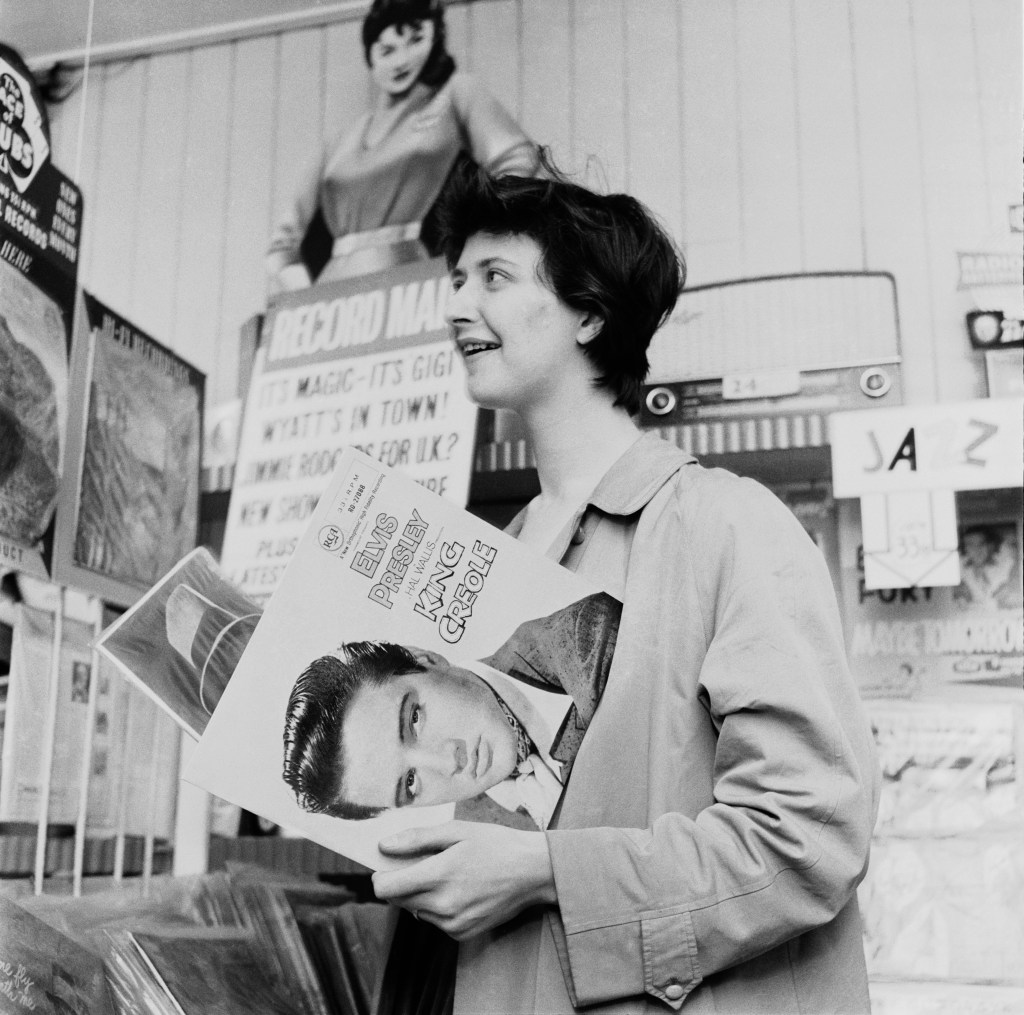 English writer Shelagh Delaney holding a copy of Elvis' album 'King Creole' in Stratford, East London, UK, 1958. 'The British Sagan from Salford' - March 1959.