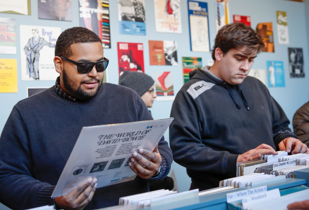Customers shop for special edition vinyl records at Dusty Groove music store during the Record Store Day in Chicago on April 13, 2019. - Record Store Day was founded in 2007 and is now celebrated at stores around the world, with hundreds of recording and other artists participating in the day by making special appearances, performances, meet and greets with their fans, the holding of fund raisers for community non-profits, and the issuing of special vinyl releases. 