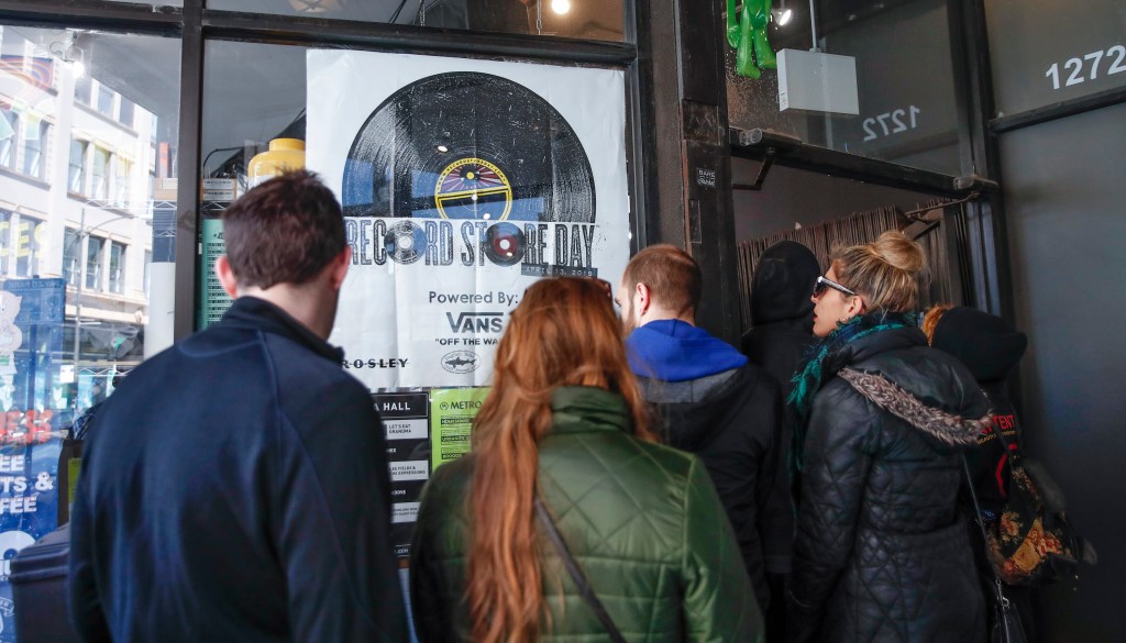 Customers wait in line to enter the Shuga Records store during the Record Store Day in Chicago on April 13, 2019. - Record Store Day was founded in 2007 and is now celebrated at stores around the world, with hundreds of recording and other artists participating in the day by making special appearances, performances, meet and greets with their fans, the holding of fund raisers for community non-profits, and the issuing of special vinyl releases. (Photo by KAMIL KRZACZYNSKI / AFP)