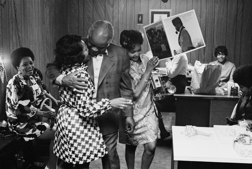 Gospel singer Roebuck 'Pops Staples of the Staple Singers attends a Stax Records sales summit titled 'Gettin' It All Together' at the Rivermont Hotel in Memphis, Tennessee, 27th May 1969. Stax are celebrating the release of 27 LPs and 30 singles, including 'Bound to Happen' by William Bell, and 'Boy Meets Girl' by various Stax artists, which can be seen hanging from the ceiling.