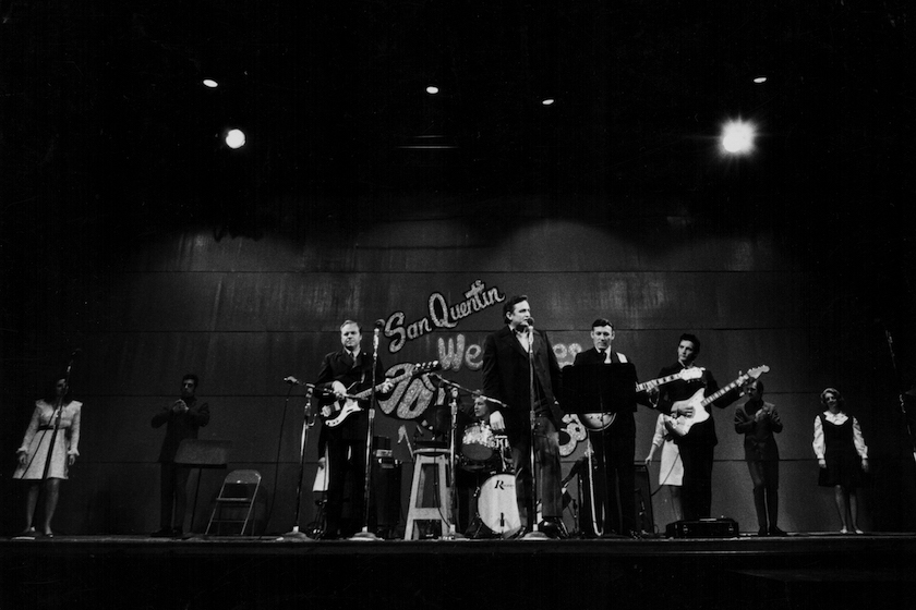 Musician Johnny Cash on stage with his band, in concert at San Quentin State Prison, California, February 24th 1969. 