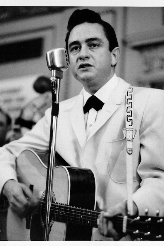 CIRCA 1958: Country singer Johnny Cash performs onstage with an acoustic guitar in circa 1958. 