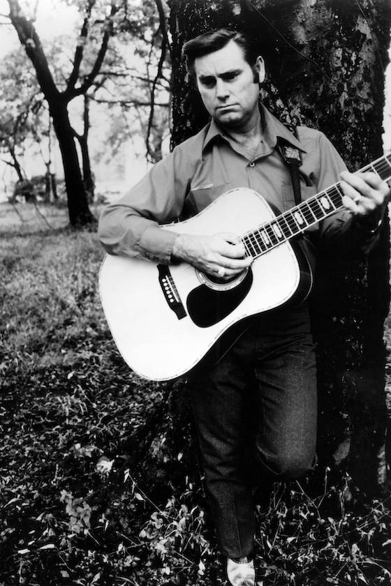 UNSPECIFIED - circa 1970: Photo of Country musician George JONES posed playing an acoustic guitar circa 1970.