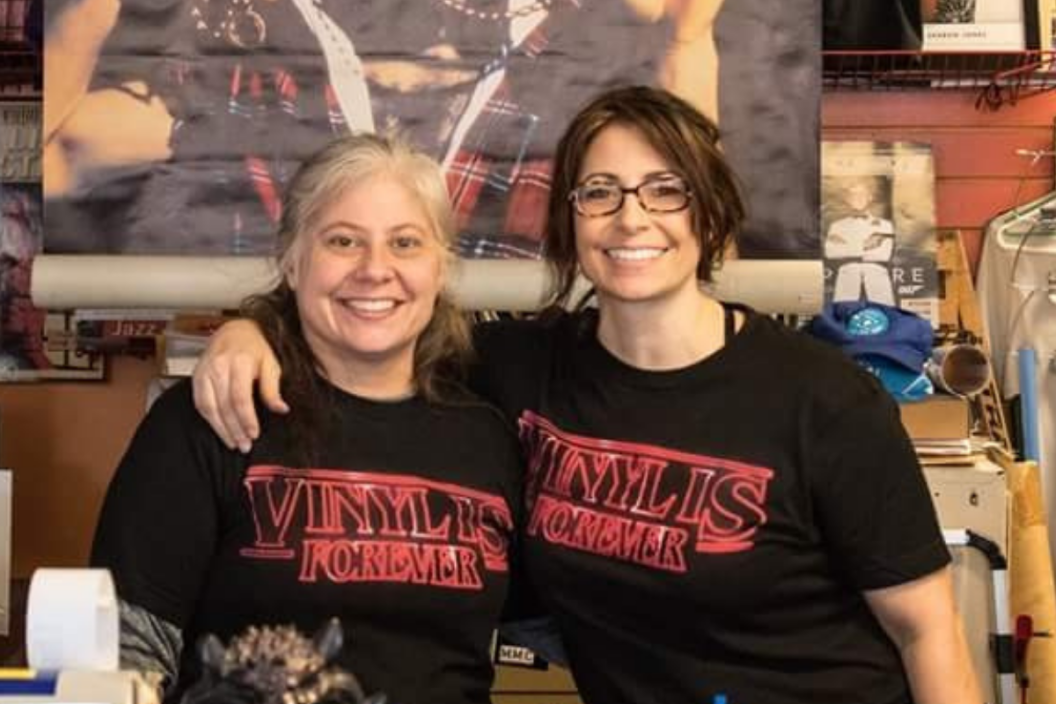Sarah and Leah Cunnick, owners of Sisters of Sound in Manhattan, Kansas, pose together inside their record store. Photo: Courtesy of Sisters of Sound