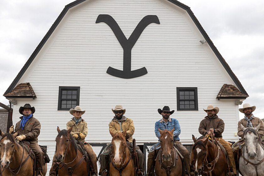 Bunkhouse crew members on horses in scene from 'Yellowstone'