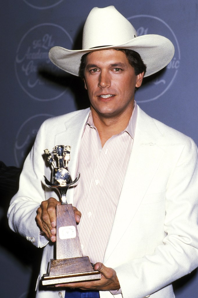 George Strait poses with award