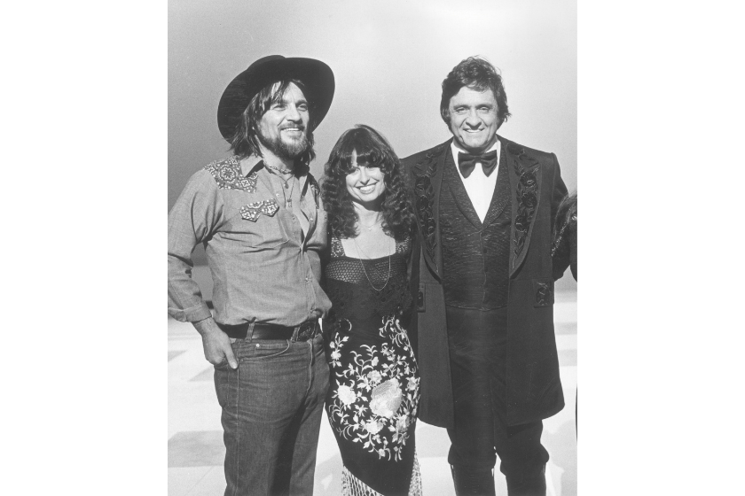 Johnny Cash stands with his guests (left to right) Waylon Jennings (1937 - 2002); Jessi Colter in a promotional portrait from Cash's television special 'Johnny Cash; Spring Fever'