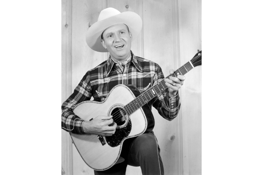 American actor and singer Gene Autry (1907 - 1998) performing with an acoustic guitar, circa 1950