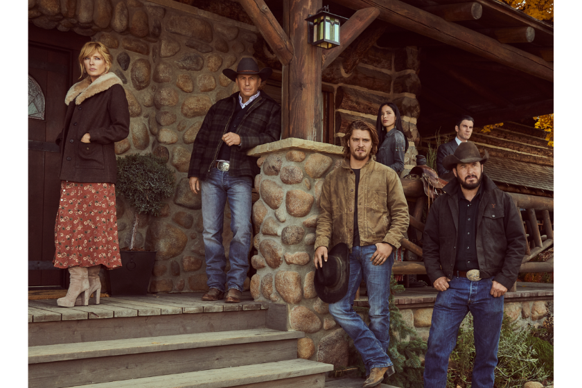 The cast of 'Yellowstone' posing on a porch in a publicity shot for the TV series 'Yellowstone'