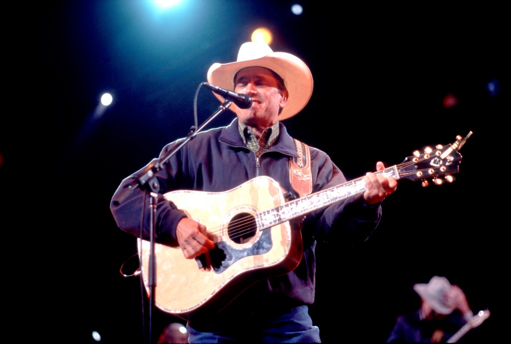 American Country musician George Strait plays guitar as he performs onstage at the Tweeter Center, Tinley Park, Illinois, May 5, 2001. 