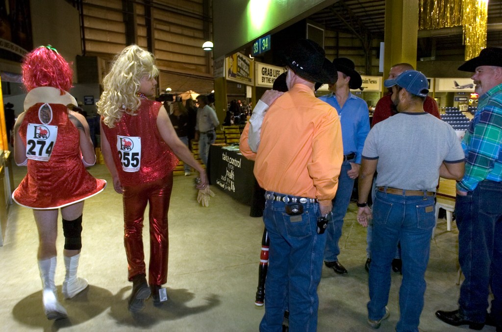 John "Taz" Yant, left, Mike Pelton get some attention prior to competing at the 31st International Gay Rodeo Association Finals Sunday at the National Western Stock Show Events Center. They were dressed for the wild drag race event, a campy addition to traditional rodeo events.