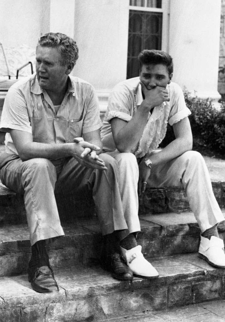 Memphis, Tennessee: Private Elvis Presley and his father numbed over the death of the singer's mother Mrs. Gladys Presley. She died this morning at a Memphis hospital of an apparent heart attack. Elvis, on a seven-day emergency furlough on the steps of the Presley mansion, with his father.