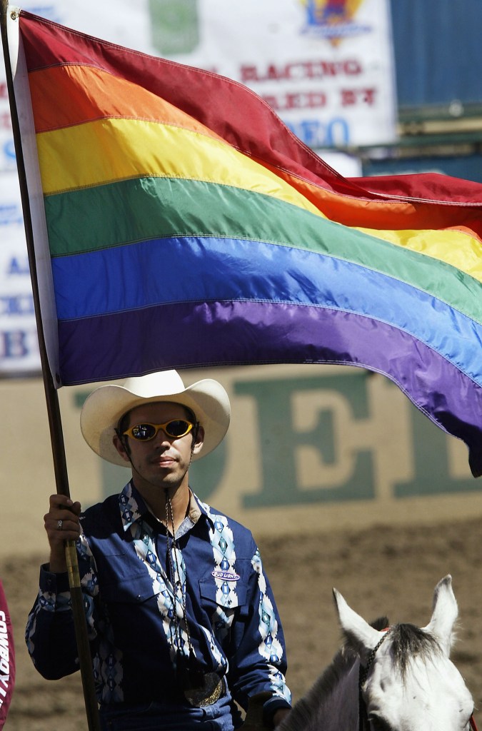 A rider carries a gay rainbow flag during the grand entry at the gay-oriented 16th Annual San Diego Rodeo, on September 18, 2004 in Del Mar, California. The San Diego Rodeo is put on by the Golden State Gay Rodeo Association (GSGRA), one of four founding associations of the International Gay Rodeo Association (IGRS). This is the 20th IGRA-sanctioned gay rodeo season in California.