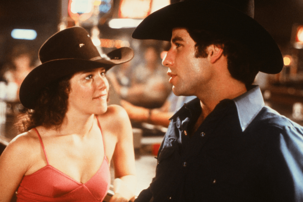 Actor John Travolta and Debra Winger talk in a scene during the Paramount Pictures movie 'Urban Cowboy" circa 1980. (Photo by Hulton Archive/Getty Images)