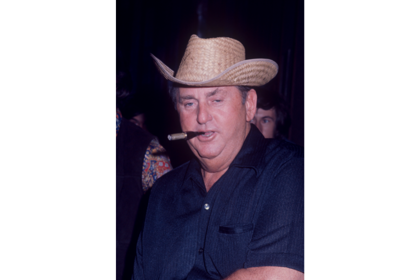 Tom Parker; Elvis Presley's manager; wearing a straw hat and smoking a cigar; circa 1970; New York