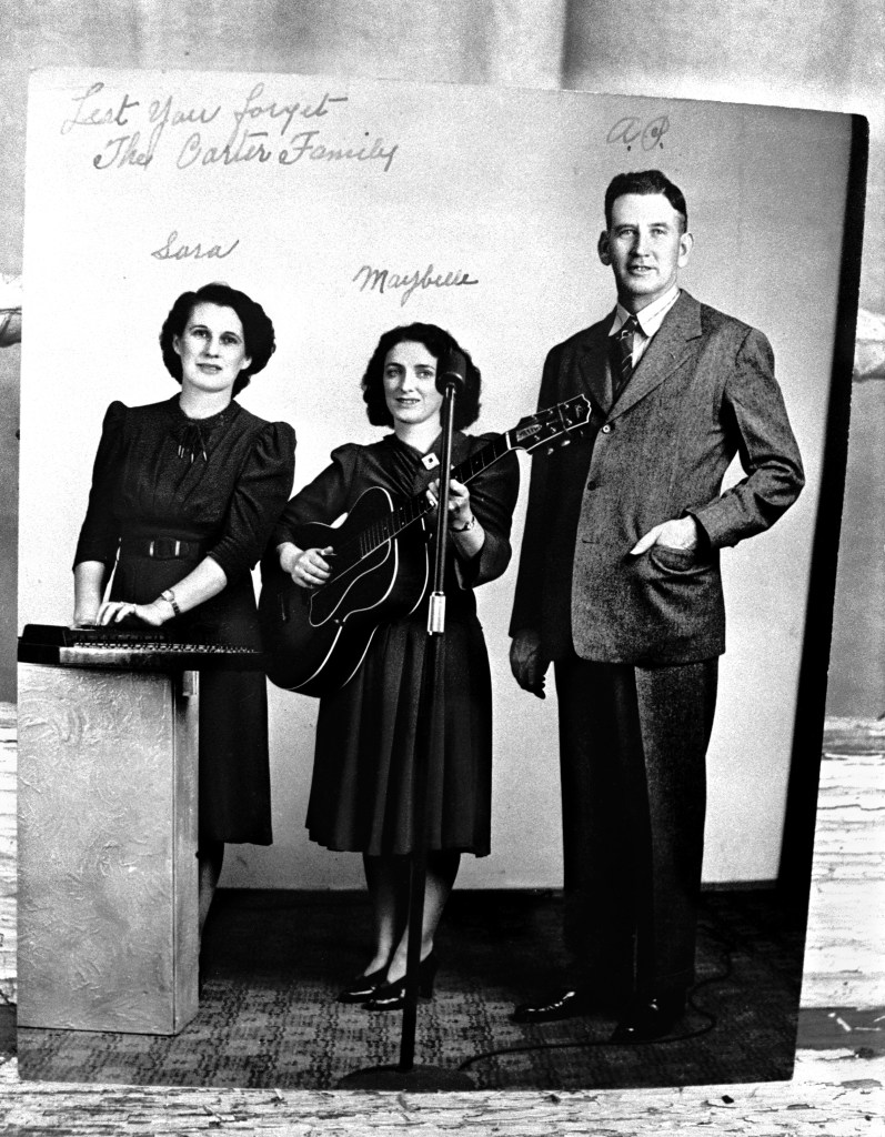 MACES SPRING, VA - JULY, 1972: A photograph of the pioneering musical group, The Carter Family, is on display at the Carter Family Museum near the musicians' birthplaces and homes in rural Maces Spring in Southwest Virginia. The Carter Family was a traditional American folk music group that recorded between 1927 and 1956. Their music had a profound impact on what would become known in later years as country and bluegrass music. The group consisted of Alvin Pleasant "A.P." Carter, his wife, Sara Carter, and his sister-in-law, Maybelle Carter.