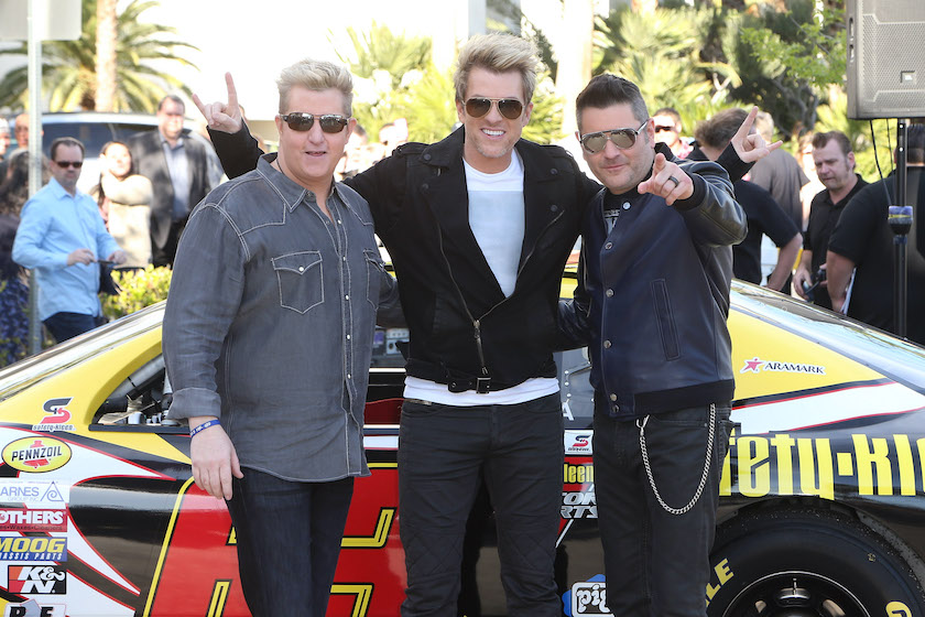 LAS VEGAS, NV - FEBRUARY 25: (L-R) Singer Gary LeVox, guitarist Joe Don Rooney and bassist Jay DeMarcus of the band Rascal Flatts pose after arriving by NASCAR race cars at the Hard Rock Hotel & Casino to kick off their residency "Rascal Flatts Vegas Riot!" on February 25, 2015 in Las Vegas, Nevada. 