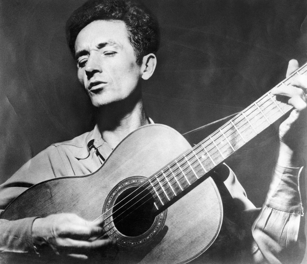 Woody Guthrie Playing the Guitar