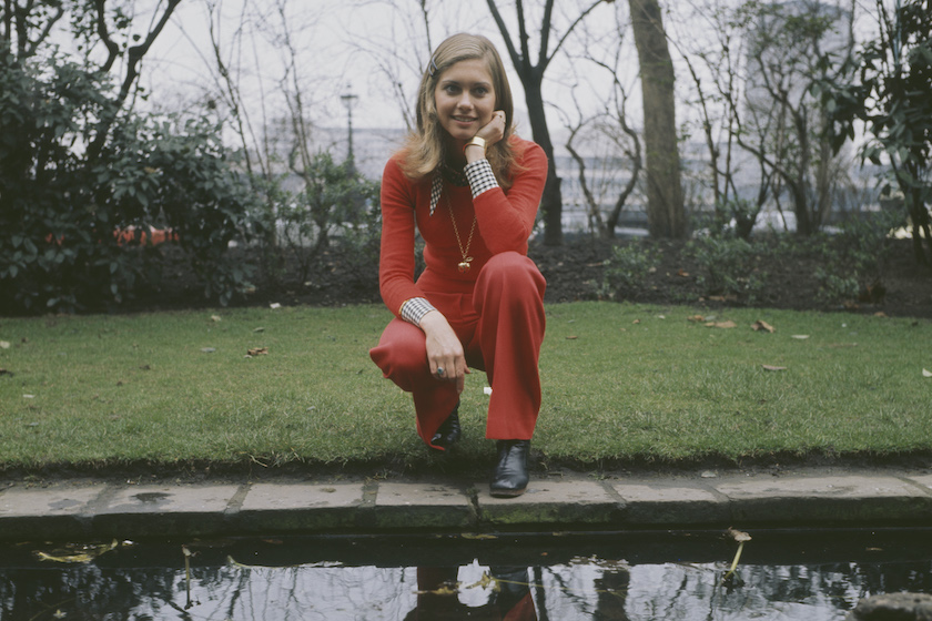 English-Australian singer, Olivia Newton-John, by a goldfish pond outside the Savoy Hotel in London, circa 1970.