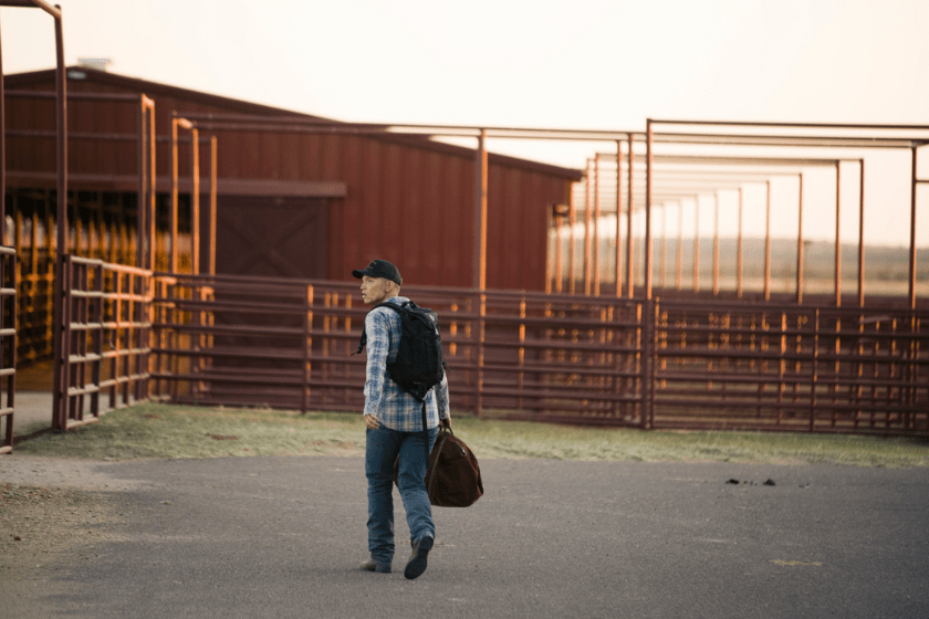 Jimmy carrying a bag walking around the 6666 Ranch in Texas