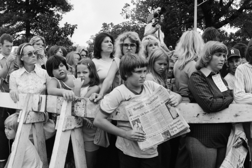A crowd gathers outside the gates of Graceland, for the funeral of Elvis Presley.