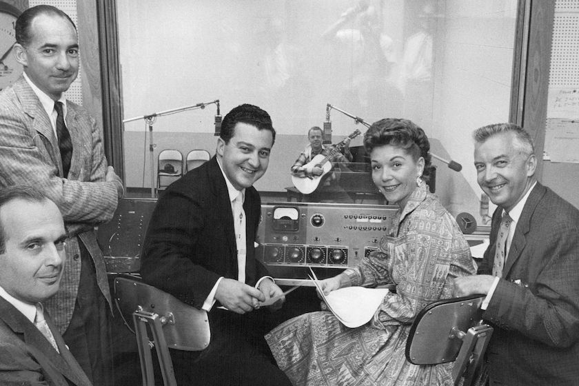 JUL 20 1956, JUL 22 1956 AUDITION CREW— Gathered in a KLZ sound booth Friday to audition local entertainers for a place on Monday night's "Arthur Godfrey's Talent Scouts" show from Cheyenne were members of the Godfrey gang from New York. They are (left to right) Burt Farber, conductor; Fred Hendrickson, "Scout" selector; Frank Musiello, producer; Janette Davis, vocalist, and Mark Russell, head talent hunter. In the background is Bob Bruso of Denver, western balladeer, first to audition. Credit: Denver Post 