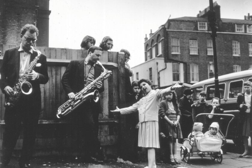 15-year-old American singing sensation Brenda Lee rehearsing in a London street for ITV's 'Oh Boy' big beat television show. A curious group of onlookers have gathered to hear her performance