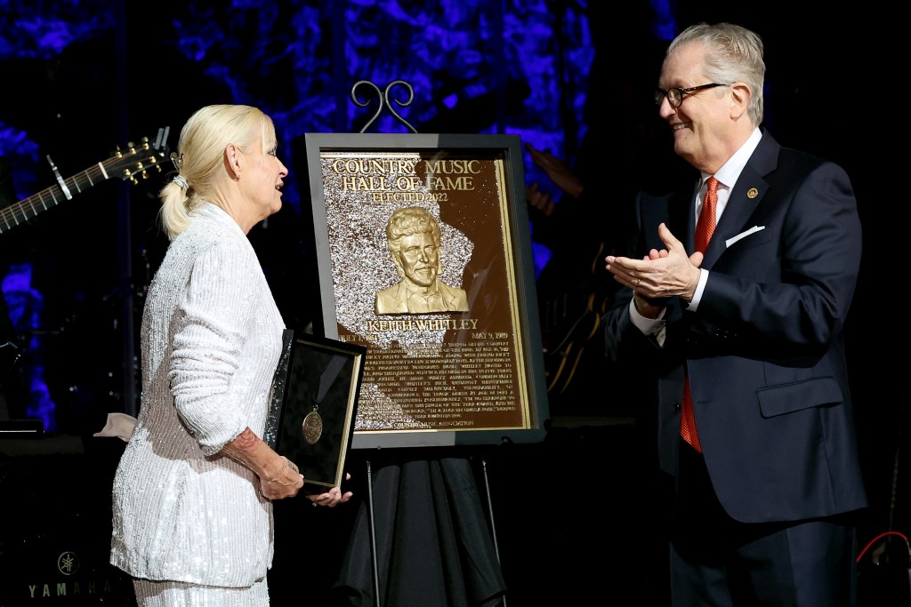 Lorrie Morgan accepts Country Music Hall of Fame and Museum induction on behalf of Keith Whitley presented by CEO of the Country Music Hall of Fame and Museum, Kyle Young (R) at the class of 2022 Medallion Ceremony at Country Music Hall of Fame and Museum on October 16, 2022 in Nashville, Tennessee. 