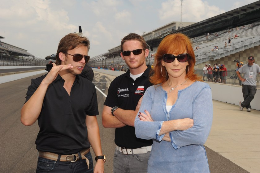INDIANAPOLIS, IN - JULY 30: (L-R) 2011 Indianapolis 500 winner Dan Wheldon, Grand-Am Continental Tire Challenge driver Shelby Blackstock and Reba McEntire arrive for the Brickyard 400 Qualifying presented by BigMachineRecords.com on July 30, 2011 in Indianapolis, Indiana. 