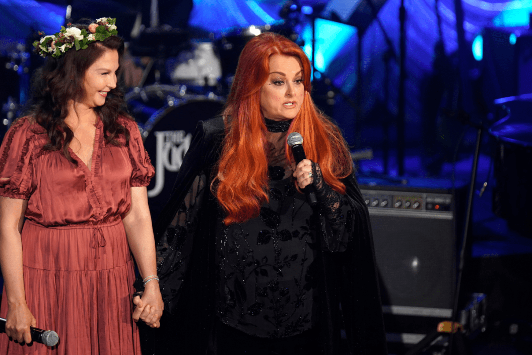 Ashley Judd and Wynonna Judd speak onstage during Naomi Judd: 'A River Of Time' Celebration at Ryman Auditorium on May 15, 2022 in Nashville, Tennessee.