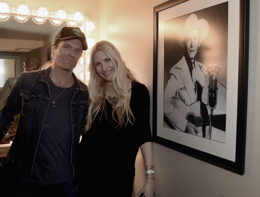 NASHVILLE, TN - MAY 07: Singer/Songerwriter Chris Coleman with Singer/Songwriter/Grand-Daughter of Hank Williams Sr., Holly Williams pose by Hank Sr. photograph in the Hank Williams room backstage at The Ryman during Sam's Place - Music For The Spirit 2017 at Ryman Auditorium on May 7, 2017 in Nashville, Tennessee. 