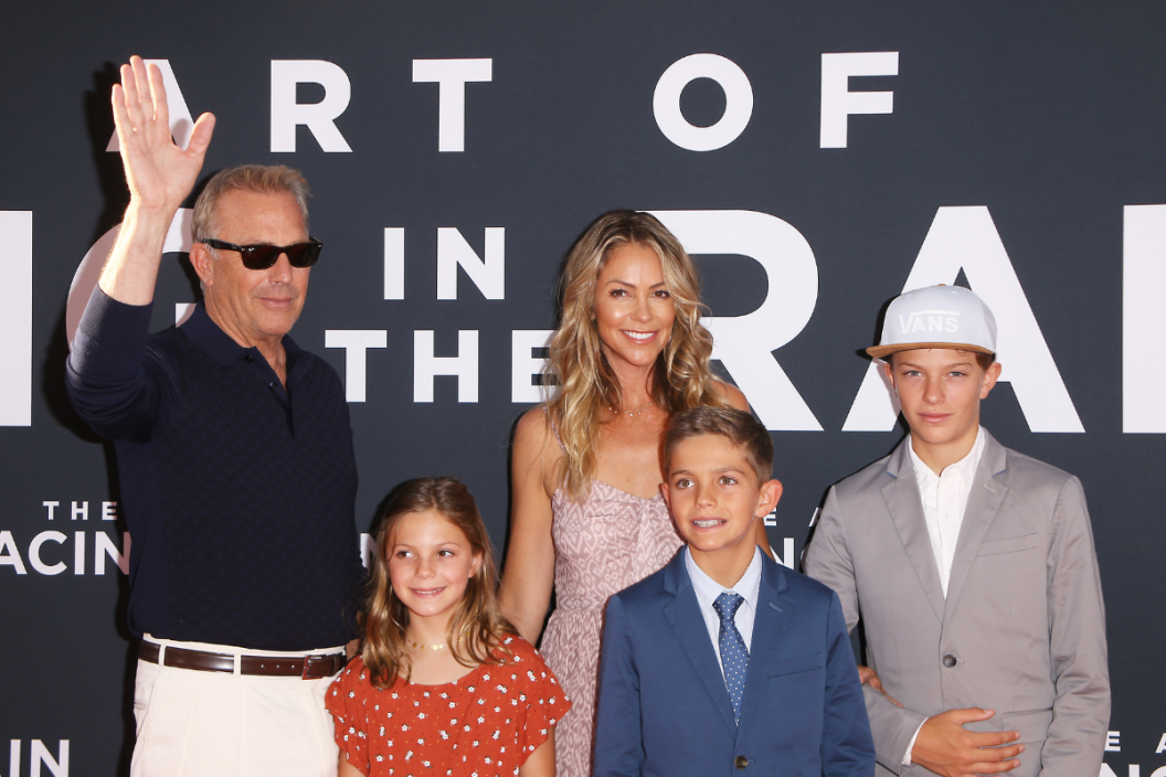 LOS ANGELES, CALIFORNIA - AUGUST 01: Kevin Costner, Christine Baumgartner and their children attend the Los Angeles premiere of 20th Century Fox's "The Art of Racing In The Rain" held at El Capitan Theatre on August 01, 2019 in Los Angeles, California. (Photo by Michael Tran/FilmMagic)