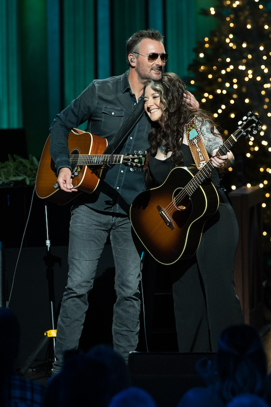 Shot from Ashley McBryde's Grand Ole Opry induction which shows her with surprise guest Eric Church