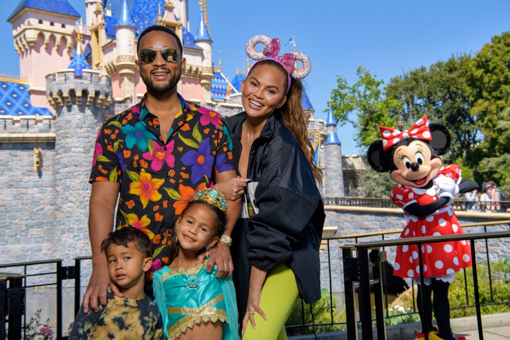 John Legend, Chrissy Teigen and their children, Miles and Luna pose with Minnie Mouse while celebrating Luna's birthday at Disneyland on April 14, 2022 in Anaheim, California.
