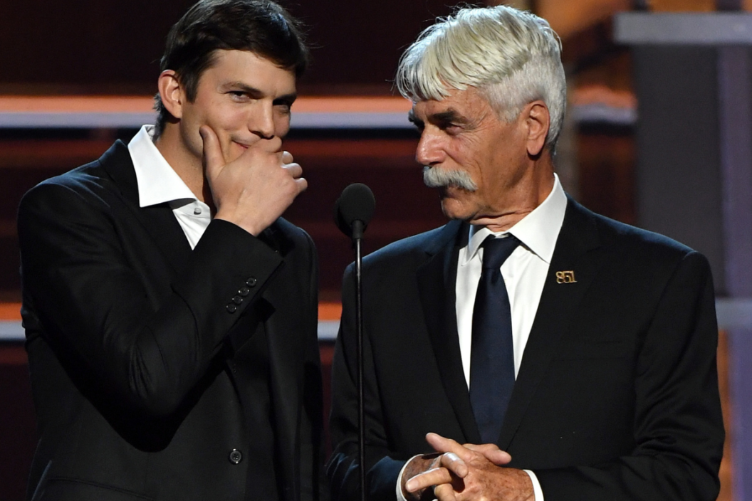 Ashton Kutcher (L) and Sam Elliott present an award during the 53rd Academy of Country Music Awards at MGM Grand Garden Arena on April 15, 2018 in Las Vegas, Nevada
