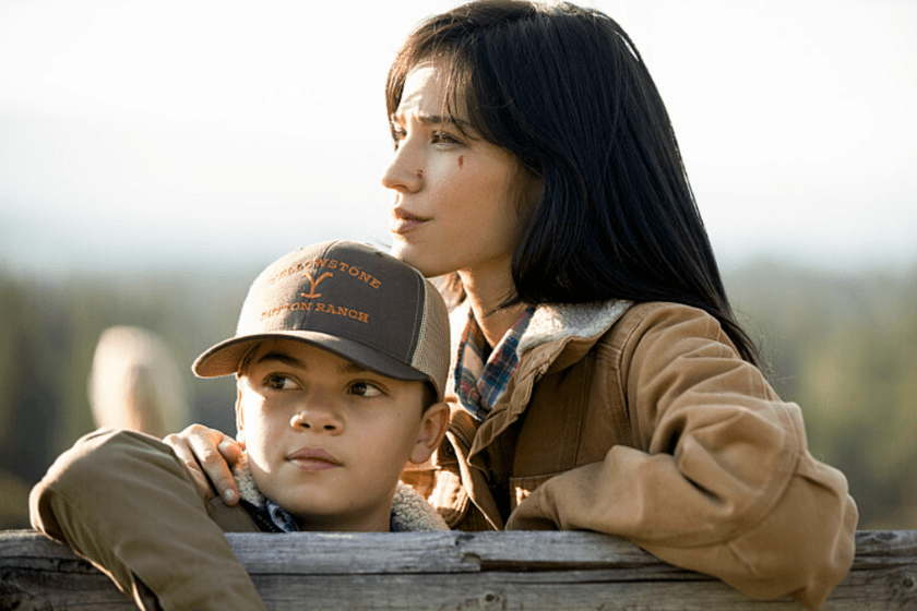 Tate and Monica Dutton lean on a fence in a scene from 'Yellowstone'