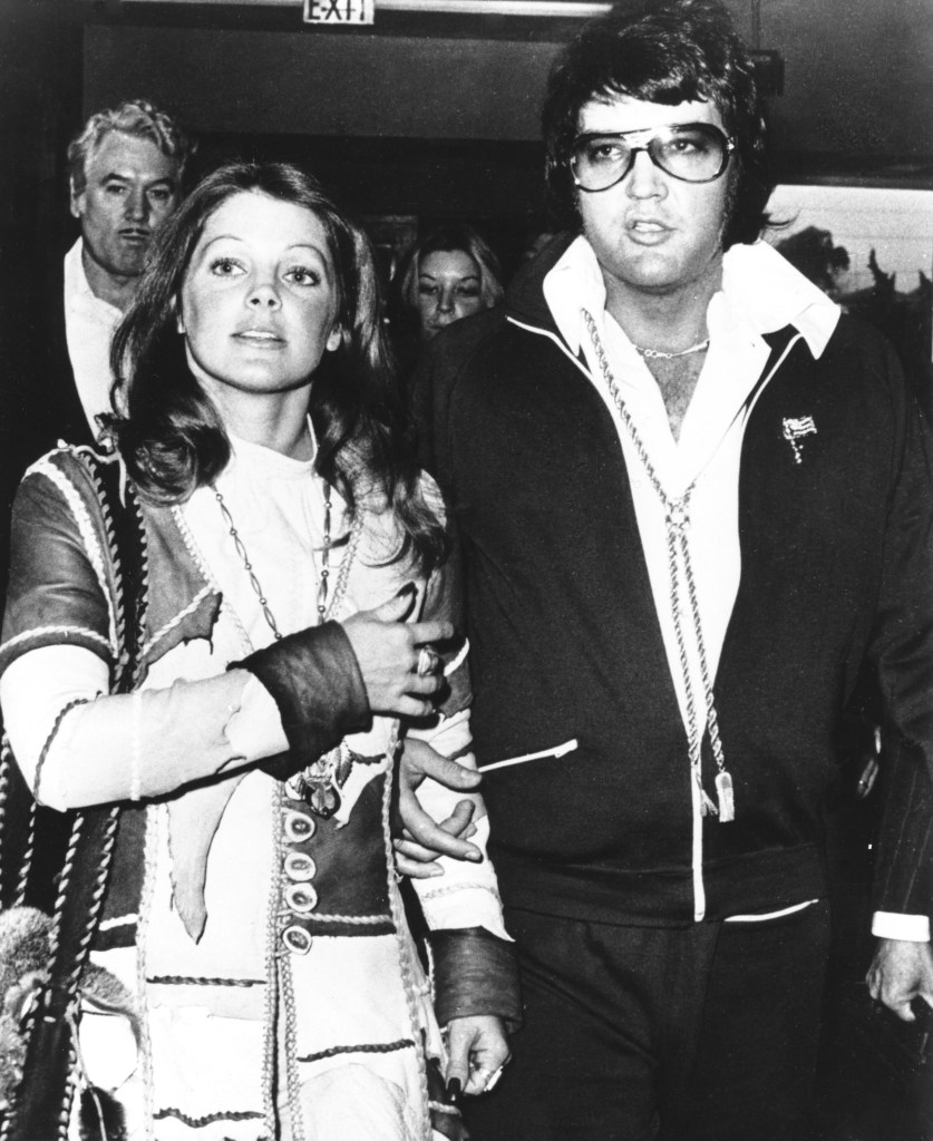 SANTA MONICA, CA - OCTOBER 9:  Rock and roll singer Elvis Presley and his wife Priscilla Beaulieu Presley leave the courthouse hand in hand following a short divorce hearing on October 9, 1973 in Santa Monica, California