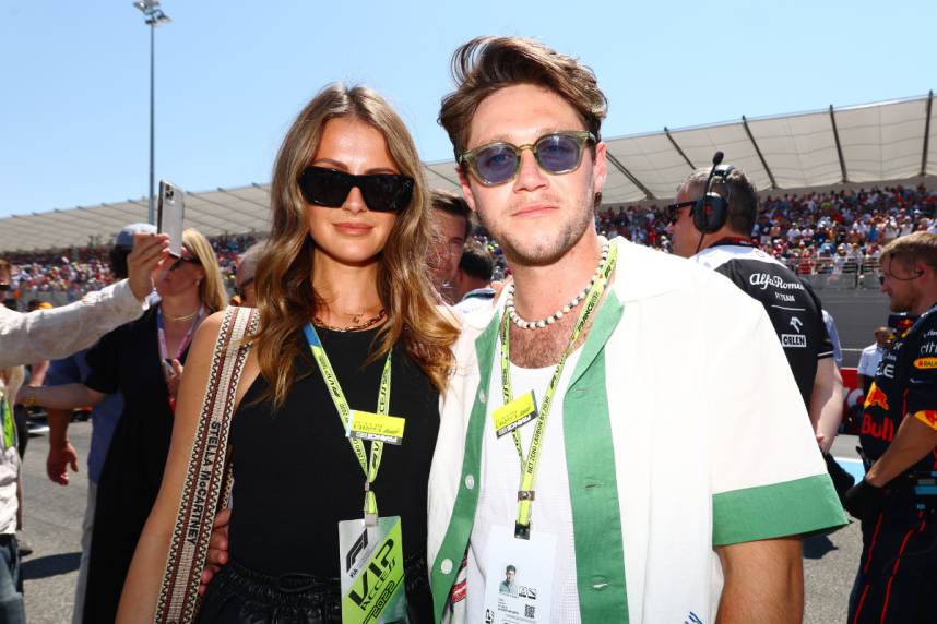 LE CASTELLET, FRANCE - JULY 24: Niall Horan and Amelia Woolley pose for a photo on the grid during the F1 Grand Prix of France at Circuit Paul Ricard on July 24, 2022 in Le Castellet, France. (