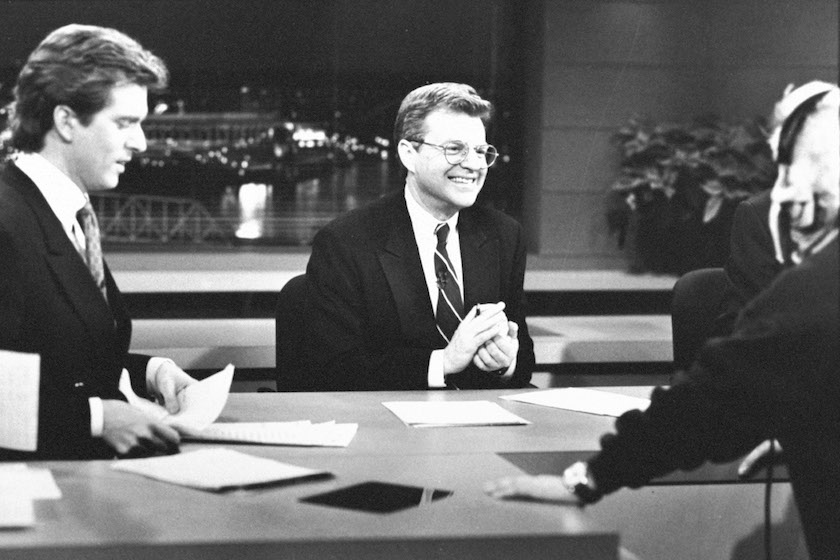 Ex-mayor/news anchorman/talk show host Jerry Springer (C) chatting w. co-anchor Jim Watkins (L) & a technician before news broadcast at WLWT-TV.