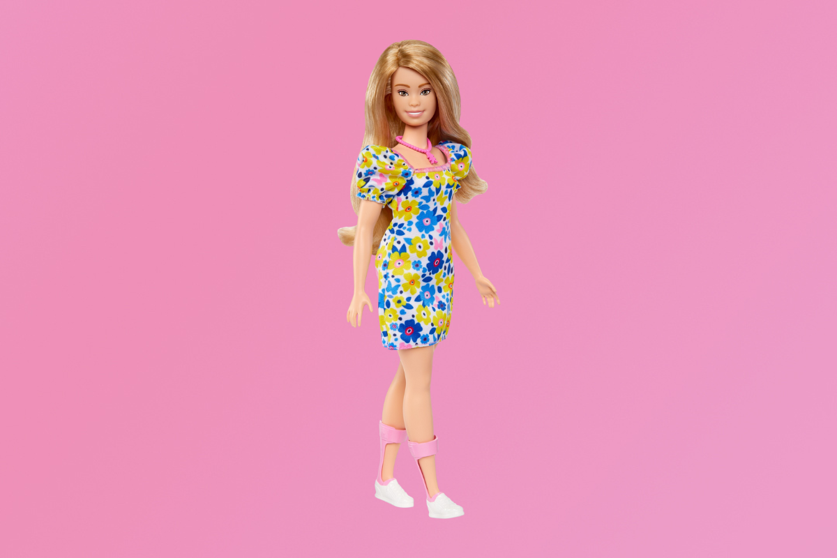 Press image of a Barbie doll with a pink background