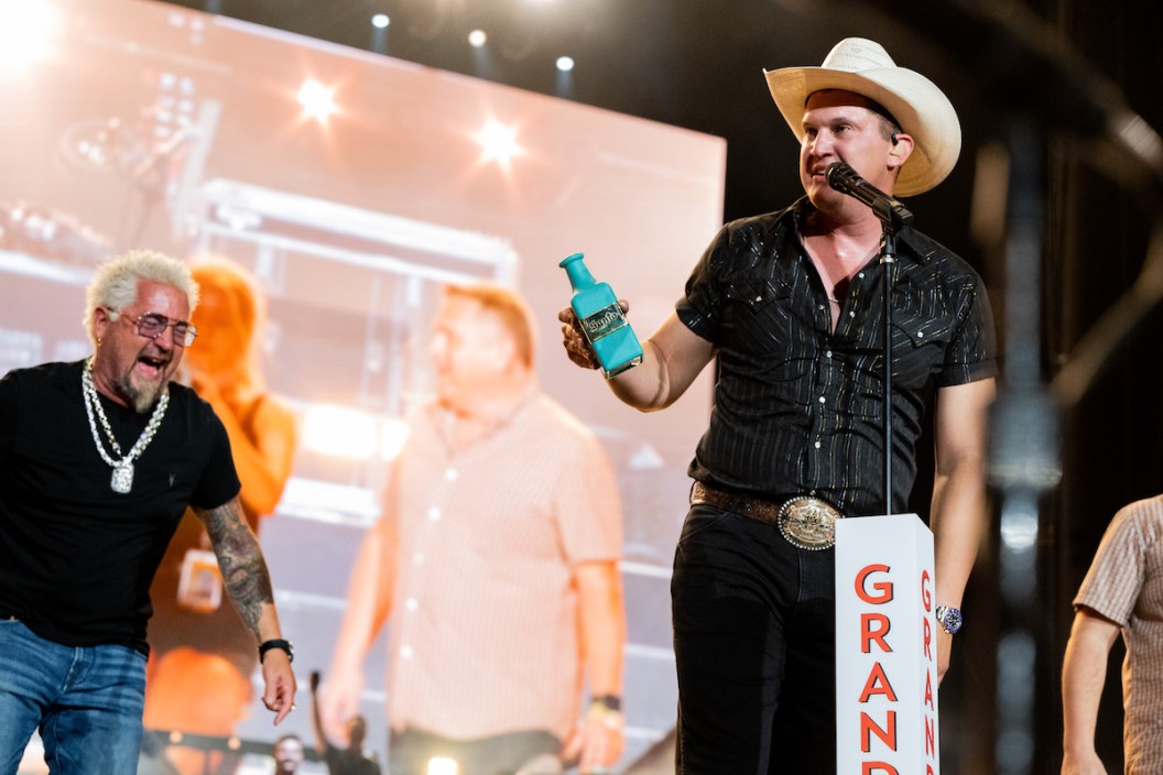 INDIO, CALIFORNIA - APRIL 28: Guy Fieri (L) inducts musician Jon Pardi (R) into the Grand Ole Opry onstage during Day 1 of the 2023 Stagecoach Festival on April 28, 2023 in Indio, California.