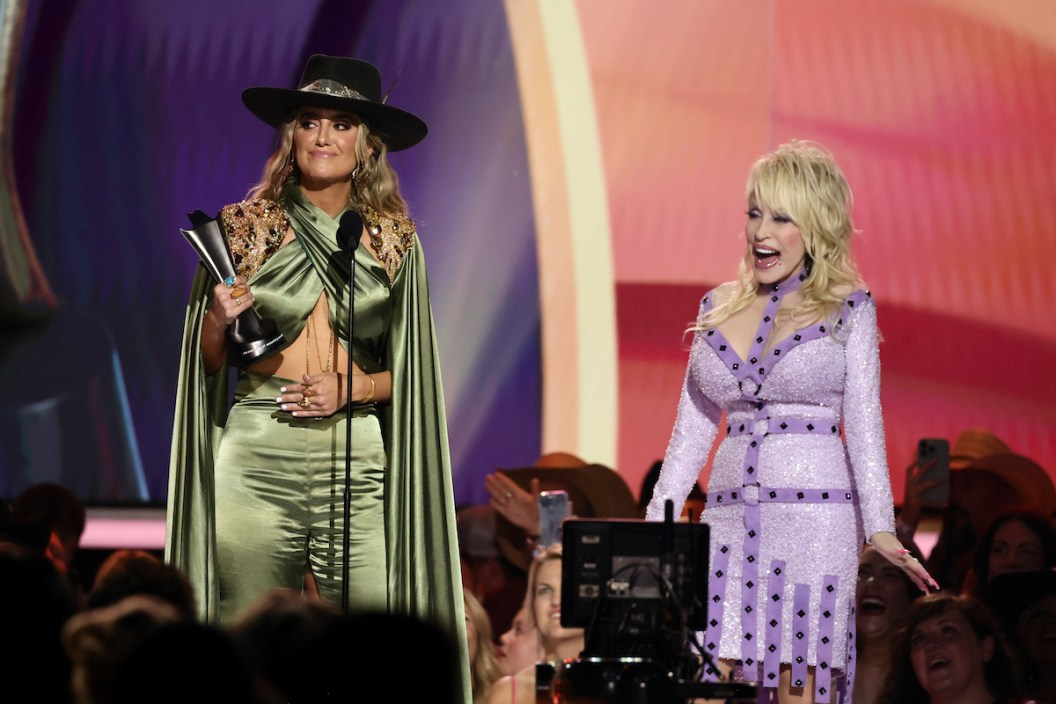 FRISCO, TEXAS - MAY 11: (L-R) Lainey Wilson accepts the Female Artist of the Year award from co-host Dolly Parton onstage during the 58th Academy Of Country Music Awards at The Ford Center at The Star on May 11, 2023 in Frisco, Texas.