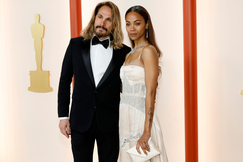 (L-R) Marco Perego and Zoe Saldana attend the 95th Annual Academy Awards on March 12, 2023 in Hollywood, California