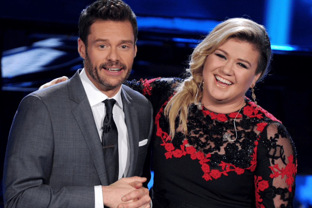 Host Ryan Seacrest (L) and singer Kelly Clarkson onstage at FOX's "American Idol XIV" Top 8 Revealed on April 1, 2015 in Hollywood, California.