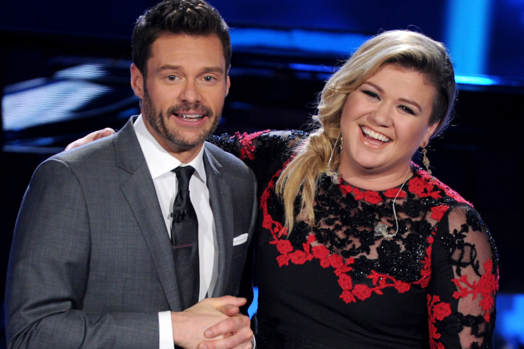 Host Ryan Seacrest (L) and singer Kelly Clarkson onstage at FOX's "American Idol XIV" Top 8 Revealed on April 1, 2015 in Hollywood, California.