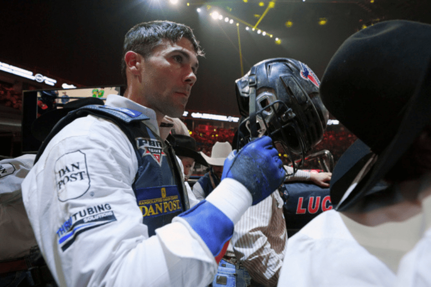 Cowboy puts on helmet in arena on 'The Ride'